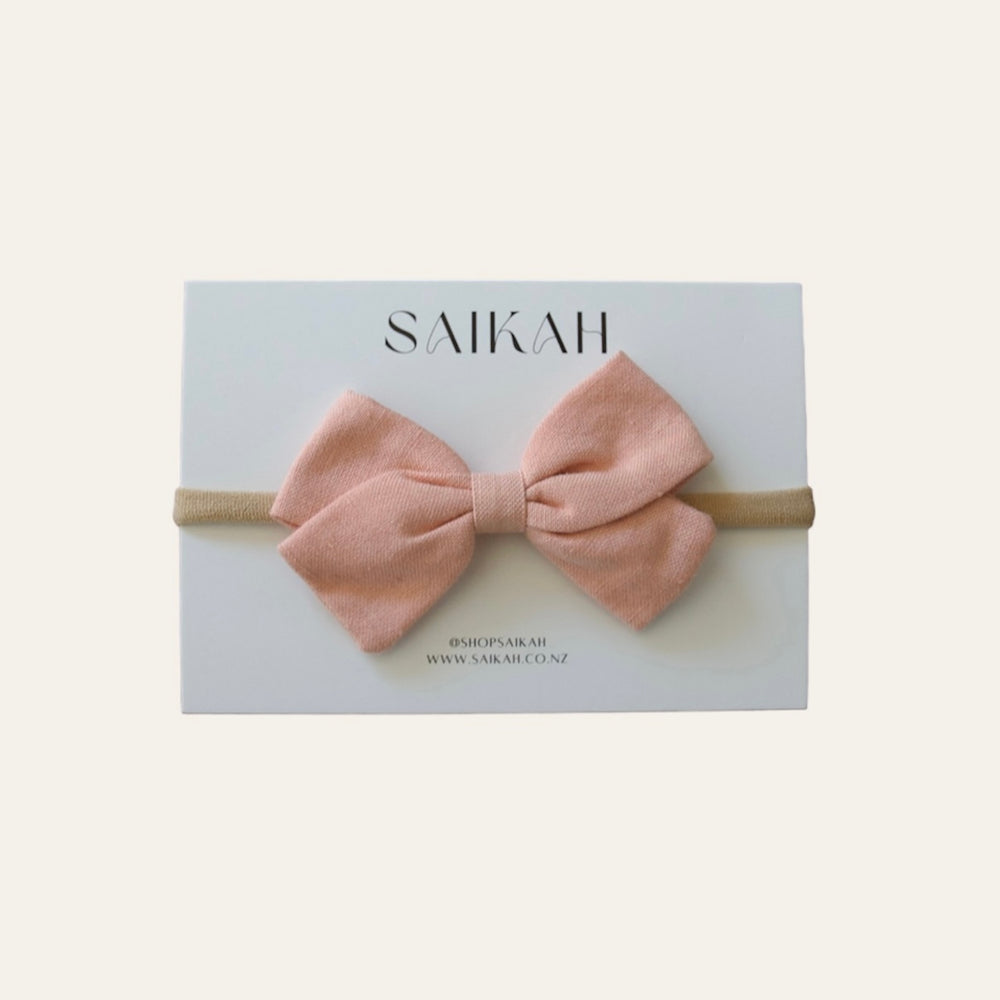 
                  
                    Saikah Peach Linen Bow Headband on White card
                  
                