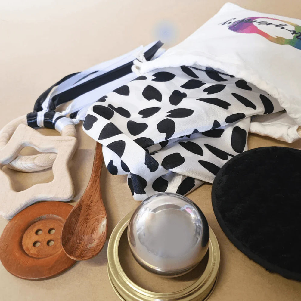 
                  
                    Baby Heuristic set of toys featuring wooden and metal objects
                  
                